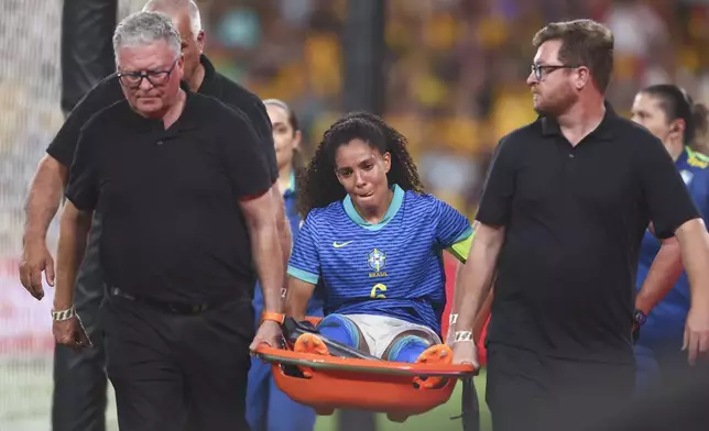 Brazil's Yasmin reacts as she is carried from the field during a soccer international between Brazil and Australia in Brisbane, Australia, Thursday, Nov. 28, 2024. (AP Photo/Pat Hoelscher)