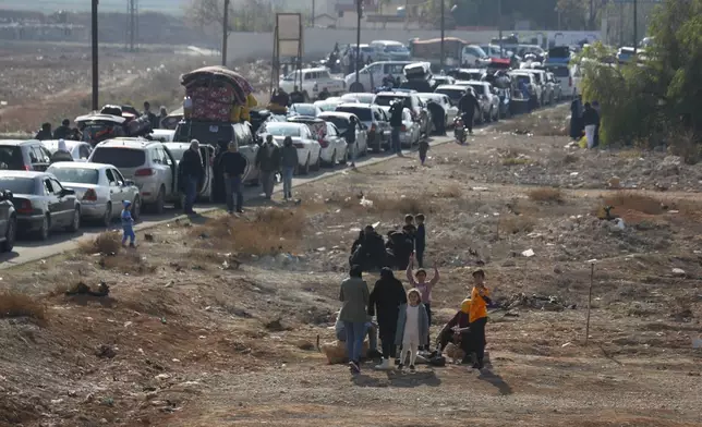 Lebanese families sit in traffic as they return to Lebanon through the Jousieh border crossing, Syria, Thursday, Nov. 28, 2024, following a ceasefire between Israel and Hezbollah that went into effect on Wednesday. (AP Photo/Omar Sanadiki)