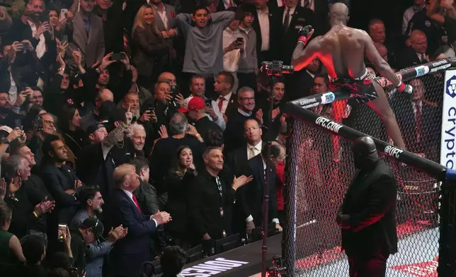 President-elect Donald Trump watches as Jon Jones reacts after defeating Stipe Miocic at UFC 309 at Madison Square Garden, early Sunday, Nov. 17, 2024, in New York. (AP Photo/Evan Vucci)