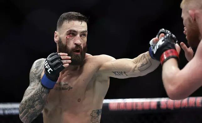 Scotland's Paul Craig punches Bo Nickal during a UFC 309 mixed martial arts middleweight title bout, Saturday, Nov. 16, 2024, in New York. (AP Photo/Adam Hunger)