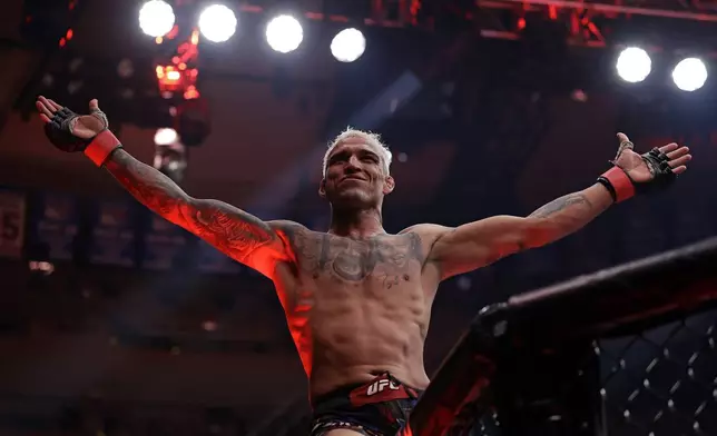 Brazil's Charles Oliveira reacts after defeating Michael Chandler in a UFC 309 mixed martial arts lightweight title bout, early on Sunday, Nov. 17, 2024, in New York. (AP Photo/Adam Hunger)