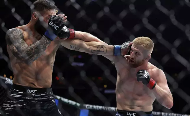 Bo Nickal, right, punches Scotland's Paul Craig in a UFC 309 mixed martial arts middleweight title bout, Saturday, Nov. 16, 2024, in New York. (AP Photo/Adam Hunger)