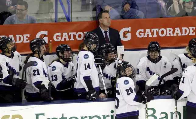 FILE - Minnesota coach Ken Klee watches a video screen during a challenge in the second period of Game 2 of a PWHL hockey championship series against Boston, May 21, 2024, in Lowell, Mass. (AP Photo/Mark Stockwell, File)