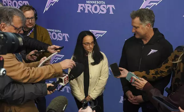 Minnesota Frost head coach Ken Klee, right, and general manager Melissa Caruso, center, talk with reporters following PWHL hockey practice Thursday, Nov. 14, 2024, in St. Paul, Minn. (Anthony Souffle/Star Tribune via AP)