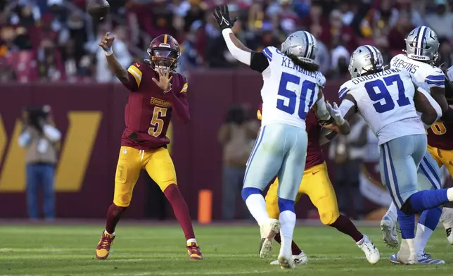 Washington Commanders quarterback Jayden Daniels (5) passes during the second half of an NFL football game against the Dallas Cowboys, Sunday, Nov. 24, 2024, in Landover, Md. (AP Photo/Stephanie Scarbrough)