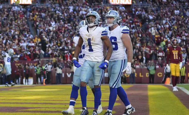 Dallas Cowboys wide receiver Jalen Tolbert (1) celebrates after scoring a 6-yard touchdown during the second half of an NFL football game against the Washington Commanders, Sunday, Nov. 24, 2024, in Landover, Md. (AP Photo/Stephanie Scarbrough)