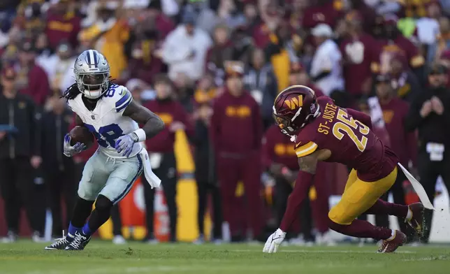 Dallas Cowboys wide receiver CeeDee Lamb (88) runs with the football as Washington Commanders cornerback Benjamin St-Juste (25) tries to tackle during the first half of an NFL football game, Sunday, Nov. 24, 2024, in Landover, Md. (AP Photo/Stephanie Scarbrough)