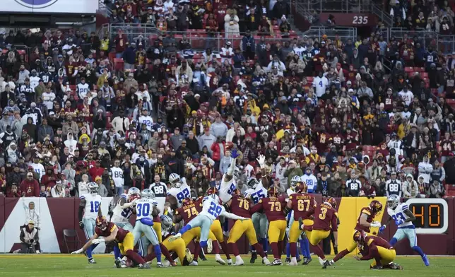 Washington Commanders place kicker Austin Seibert (3) kicks an unsuccessful point after attempt during the second half of an NFL football game against the Dallas Cowboys, Sunday, Nov. 24, 2024, in Landover, Md. (AP Photo/Stephanie Scarbrough)