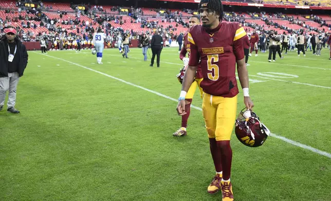 Washington Commanders quarterback Jayden Daniels (5) walks across the field after the 34-26 loss to the Dallas Cowboys of an NFL football game, Sunday, Nov. 24, 2024, in Landover, Md. (AP Photo/Nick Wass)