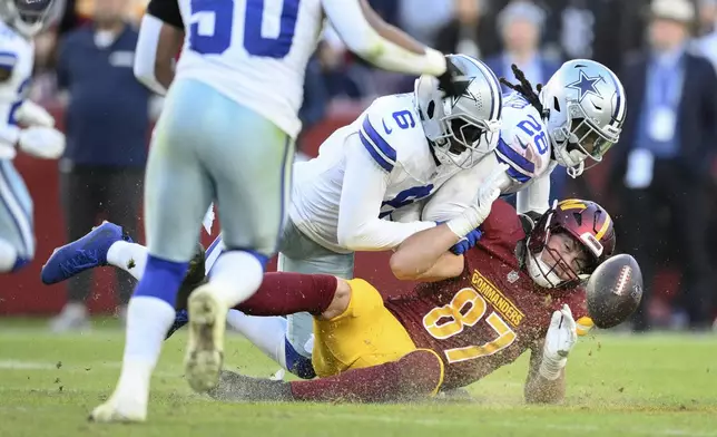 Washington Commanders tight end John Bates (87) fumbles during the second half of an NFL football game against the Dallas Cowboys, Sunday, Nov. 24, 2024, in Landover, Md. (AP Photo/Nick Wass)