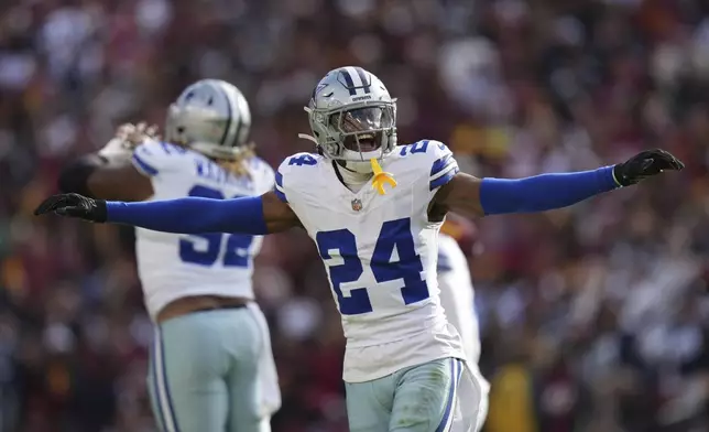 Dallas Cowboys safety Israel Mukuamu (24) celebrates after a missed field goal attempt by Washington Commanders place kicker Austin Seibert (3) during the first half of an NFL football game, Sunday, Nov. 24, 2024, in Landover, Md. (AP Photo/Stephanie Scarbrough)