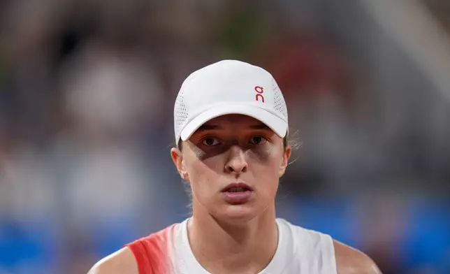 FILE - Iga Swiatek of Poland looks on during her match against Irina-Camelia Begu of Romania during a women's singles tennis competition, at the 2024 Summer Olympics, Saturday, July 27, 2024, in Paris, France. (AP Photo/Manu Fernandez, File)