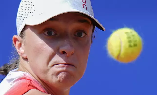 FILE - Iga Swiatek of Poland eyes on the ball as she plays against Anna Karolina Schmiedlova of Slovakia during their women's bronze medal match, at the 2024 Summer Olympics, Friday, Aug. 2, 2024, at the Roland Garros stadium in Paris, France. (AP Photo/Andy Wong, File)