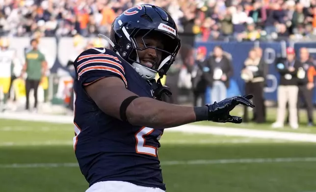 Chicago Bears' Roschon Johnson celebrates his touchdown run during the first half of an NFL football game against the Green Bay Packers Sunday, Nov. 17, 2024, in Chicago. (AP Photo/Charles Rex Arbogast)