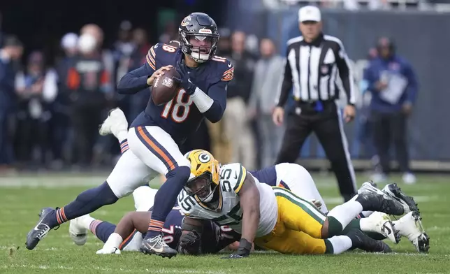 Chicago Bears' Caleb Williams runs during the first half of an NFL football game against the Green Bay Packers Sunday, Nov. 17, 2024, in Chicago. (AP Photo/Charles Rex Arbogast)