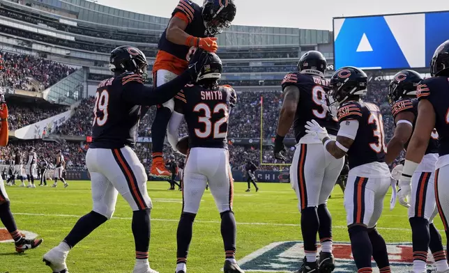 Chicago Bears' Kyler Gordon congratulates MarShawn Lloyd (32) after Lloyd's interception during the first half of an NFL football game against the Green Bay Packers Sunday, Nov. 17, 2024, in Chicago. (AP Photo/Nam Y. Huh)