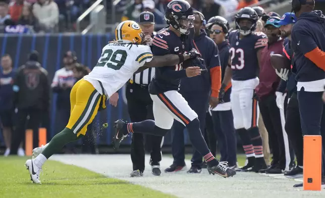 Chicago Bears' Caleb Williams is stopped by Green Bay Packers' Xavier McKinney during the first half of an NFL football game Sunday, Nov. 17, 2024, in Chicago. McKinney was called for a penalty on the play. (AP Photo/Nam Y. Huh)