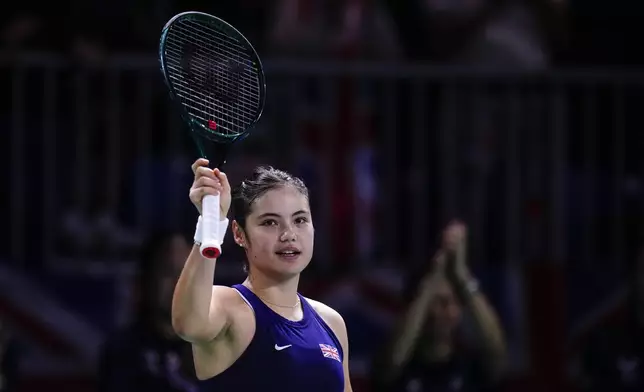 Emma Raducanu of Britain celebrates after winning in the match against Canada's Rebecca Marino during the Billie Jean King Cup Finals, at the Martin Carpena Sports Hall, in Malaga, southern Spain, on Sunday, Nov. 17, 2024. (AP Photo/Manu Fernandez)