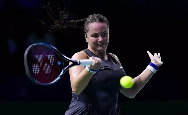 Slovakia's Viktoria Hruncakova returns the ball to Australia's Kimberly Birrell during the Billie Jean King Cup Finals, at the Martin Carpena Sports Hall, in Malaga, southern Spain, on Sunday, Nov. 17, 2024. (AP Photo/Manu Fernandez)