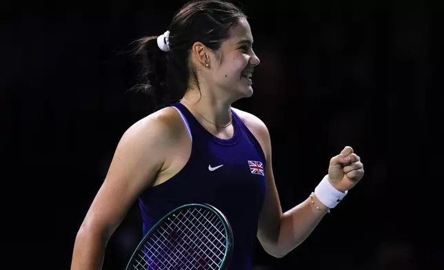 Emma Raducanu of Britain celebrates after winning the match against Canada's Rebecca Marino during the Billie Jean King Cup Finals, at the Martin Carpena Sports Hall, in Malaga, southern Spain, on Sunday, Nov. 17, 2024. (AP Photo/Manu Fernandez)
