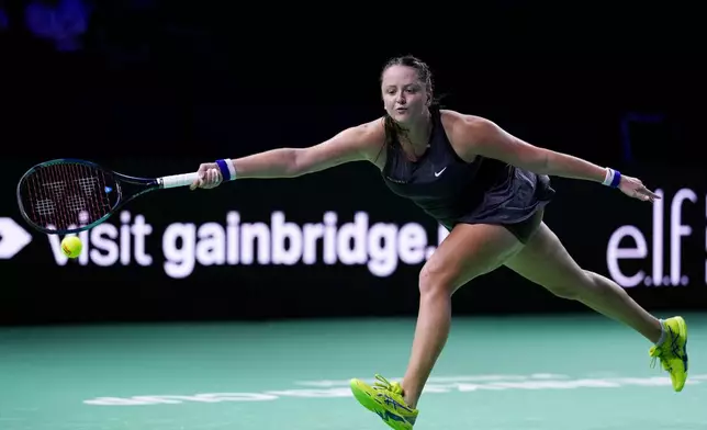 Slovakia's Viktoria Hruncakova returns the ball to Australia's Kimberly Birrell during the Billie Jean King Cup Finals, at the Martin Carpena Sports Hall, in Malaga, southern Spain, on Sunday, Nov. 17, 2024. (AP Photo/Manu Fernandez)