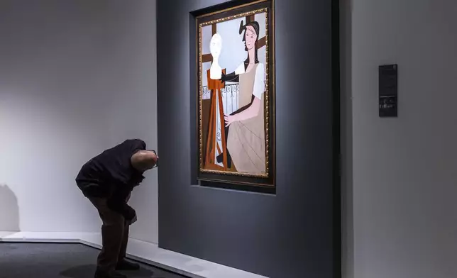 A man takes a look at "La Statuaire," by Pablo Picasso, during an auction preview at Sotheby's in New York, Monday, Nov, 11, 2024. (AP Photo/Eduardo Munoz Alvarez)