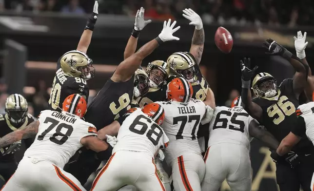 A number of New Orleans Saints defenders attempt to block a field goal by the Cleveland Browns in the first half of an NFL football game in New Orleans, Sunday, Nov. 17, 2024. The field goal was no good. (AP Photo/Gerald Herbert)