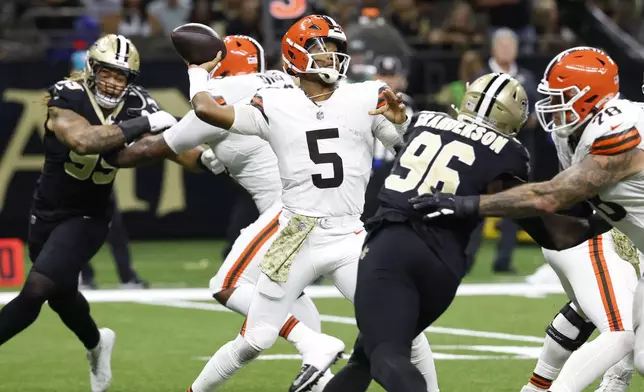 Cleveland Browns quarterback Jameis Winston (5) passes under pressure in the first half of an NFL football game against the New Orleans Saints in New Orleans, Sunday, Nov. 17, 2024. (AP Photo/Butch Dill)