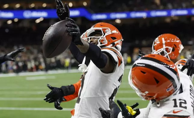 Cleveland Browns cornerback Denzel Ward, left, celebrates an interception in the first half of an NFL football game against the New Orleans Saints in New Orleans, Sunday, Nov. 17, 2024. (AP Photo/Butch Dill)