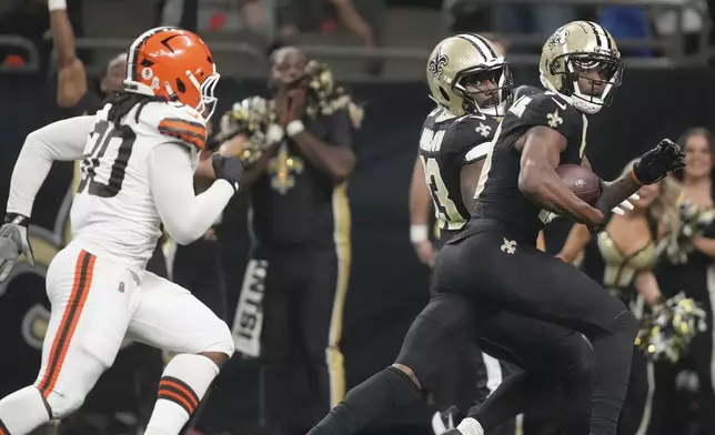 New Orleans Saints wide receiver Marquez Valdes-Scantling looks over his shoulder at Cleveland Browns linebacker Devin Bush (30) as he scores in the first half of an NFL football game in New Orleans, Sunday, Nov. 17, 2024. (AP Photo/Gerald Herbert)