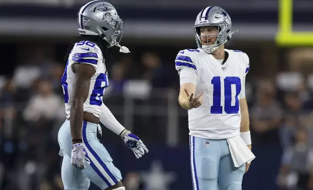 Dallas Cowboys quarterback Cooper Rush (10) and wide receiver CeeDee Lamb walk off the field after Rush threw an interception against the Houston Texans during the first half of an NFL football game, Monday, Nov. 18, 2024, in Arlington, Texas. (AP Photo/Gareth Patterson)