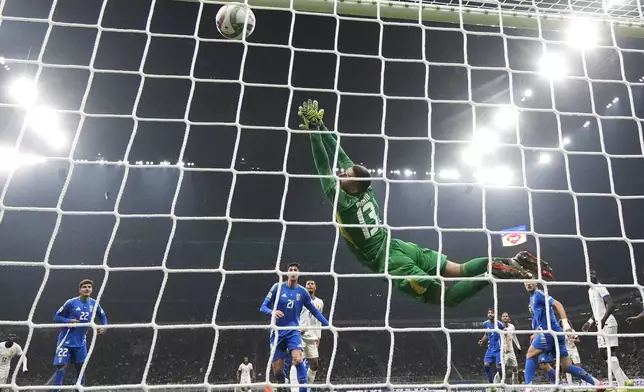 Italy goalkeeper Guglielmo Vicario misses the third goal during the Nations League soccer match between Italy and France, at the San Siro stadium in Milan, Italy, Sunday, Nov. 17, 2024. (AP Photo/Luca Bruno)