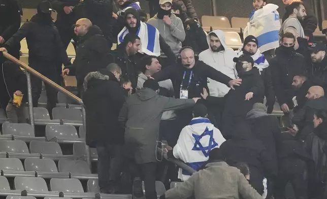 Fans argue in stands during the UEFA Nations League soccer match between France and Israel at the Stade de France stadium in Saint-Denis, outside Paris, Thursday Nov. 14, 2024. (AP Photo/Thibault Camus)