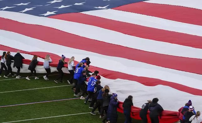 People practice folding a giant United States flag before an NFL football game between the Buffalo Bills and the Kansas City Chiefs, Sunday, Nov. 17, 2024, in Orchard Park, N.Y. (AP Photo/Julia Demaree Nikhinson)