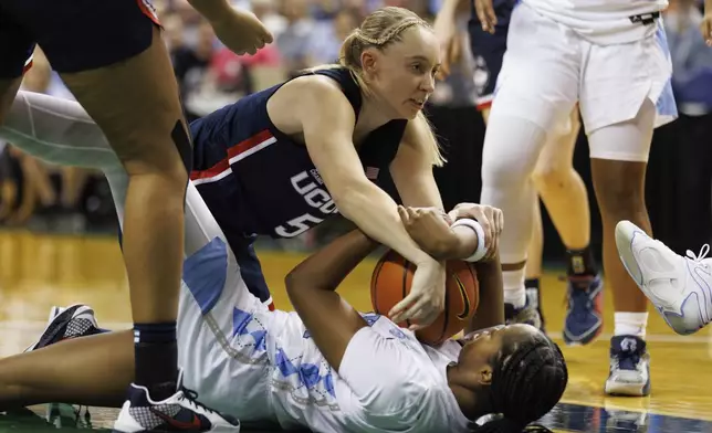 UConn's Paige Bueckers (5) battles North Carolina's Laila Hull, right, for a loose ball during the second half of an NCAA college basketball game in Greensboro, N.C., Friday, Nov. 15, 2024. (AP Photo/Ben McKeown)