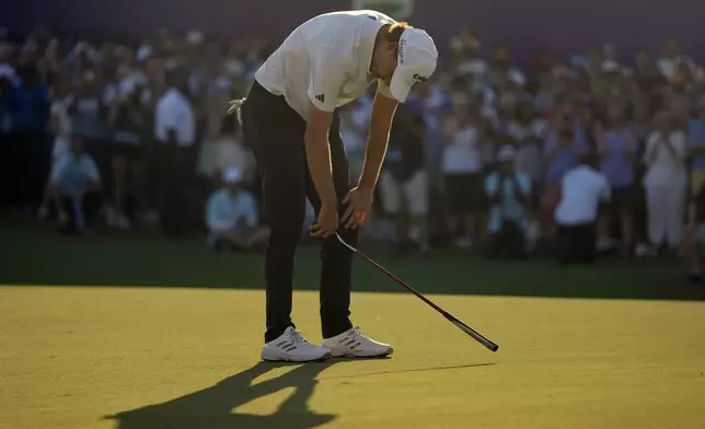 Rasmus Højgaard of Denmark reacts after missing a shot on the 18th hole in the final round of World Tour Golf Championship in Dubai, United Arab Emirates, Sunday, Nov. 17, 2024. (AP Photo/Altaf Qadri)