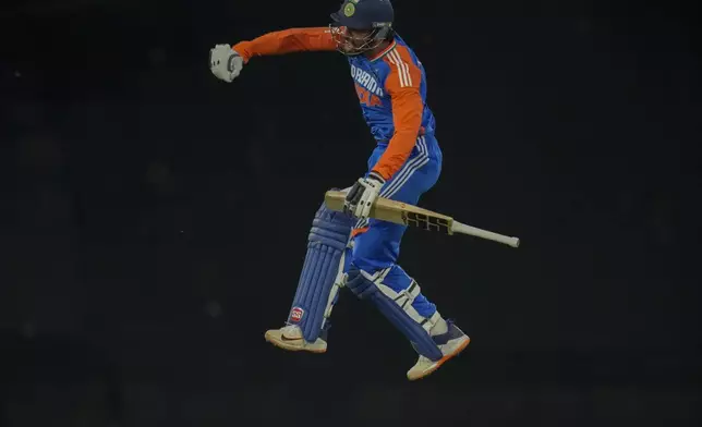 India's Tilak Varma jumps in the air as he celebrates after scoring a century during the third T20 International cricket match between South Africa and India, at Centurion Park in Centurion, South Africa, Wednesday, Nov. 13, 2024. (AP Photo/Themba Hadebe)