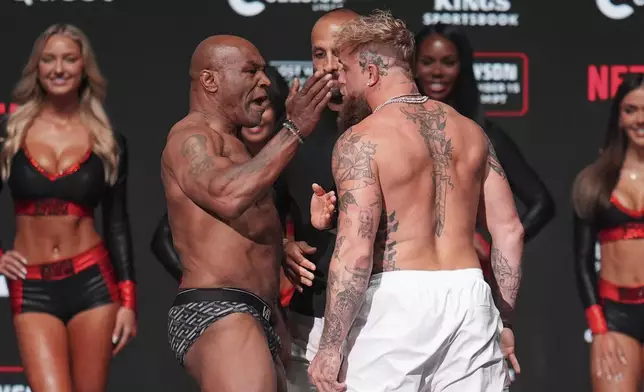 Mike Tyson, left, slaps Jake Paul during a weigh-in ahead of their heavyweight bout, Thursday, Nov. 14, 2024, in Irving, Texas. (AP Photo/Julio Cortez)