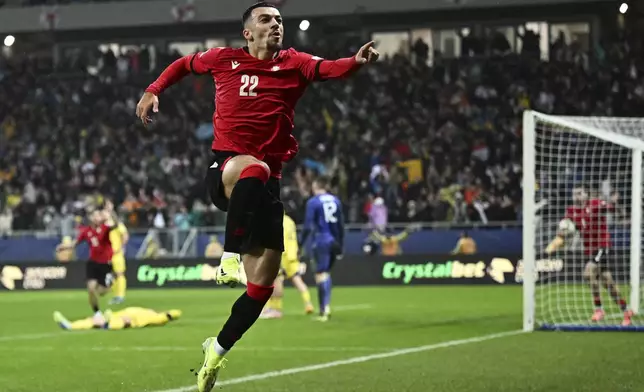 Georgia's Georges Mikautadze celebrates after scoring his side's first goal during the UEFA Nations League, group B1 soccer match between Georgia and Ukraine at the AdjaraBet Arena in Batumi, Georgia, Saturday, Nov. 16, 2024. (AP Photo/Tamuna Kulumbegashvili)