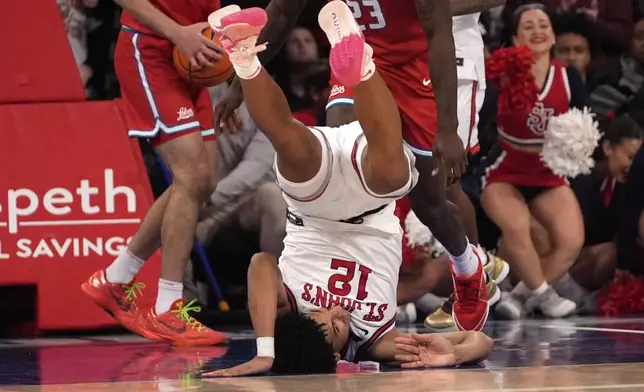 St. John's guard RJ Luis Jr. (12) falls after driving to the basket during the second half of an NCAA college basketball game against New Mexico, Sunday, Nov. 17, 2024, in New York. (AP Photo/Pamela Smith)