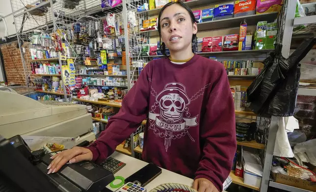 College student Jimena Sanchez, right, who studies children's development works as a part-time cashier earning minimum wage at a family store, in Los Angeles on Oct. 11, 2024. (AP Photo/Damian Dovarganes)