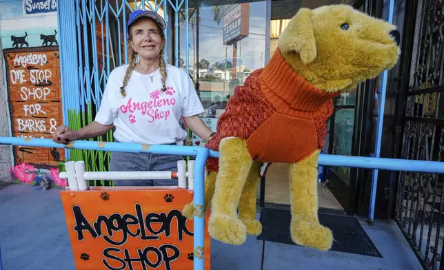 Business owner Silvia Navarro, who recently opened a dog and cat food supply store, poses for a photo outside her store in Los Angeles on Oct. 11, 2024. (AP Photo/Damian Dovarganes)