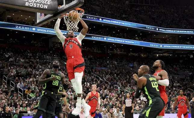 Toronto Raptors guard RJ Barrett (9) dunks the ball during the first half of an NBA basketball game against the Boston Celtics, Saturday, Nov. 16, 2024, in Boston. (AP Photo/Mark Stockwell)