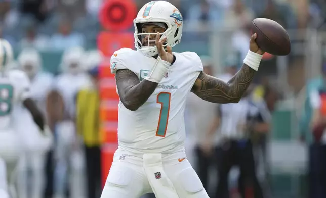 Miami Dolphins quarterback Tua Tagovailoa (1) aims a pass during the first half of an NFL football game against the New England Patriots, Sunday, Nov. 24, 2024, in Miami Gardens, Fla. (AP Photo/Lynne Sladky)