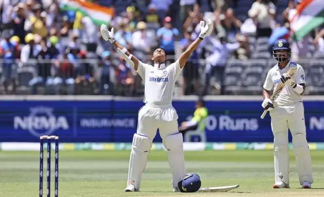 India's Yashasvi Jaiswal, left, celebrates his century as teammate India's KL Rahul applauds on the third day of the first cricket test between Australia and India in Perth, Australia, Sunday, Nov. 24, 2024. (AP Photo/Trevor Collens)