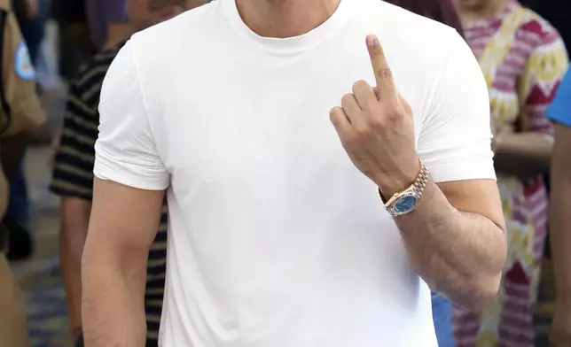 Bollywood actor Ranbir Kapoor shows the ink mark on his index finger after casting his vote in the Maharashtra state assembly elections in Mumbai, India, Wednesday, Nov. 20, 2024. (AP Photo/Satyajit Desai)