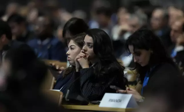 Attendees listen during a session on urbanization at the COP29 U.N. Climate Summit, Wednesday, Nov. 20, 2024, in Baku, Azerbaijan. (AP Photo/Rafiq Maqbool)