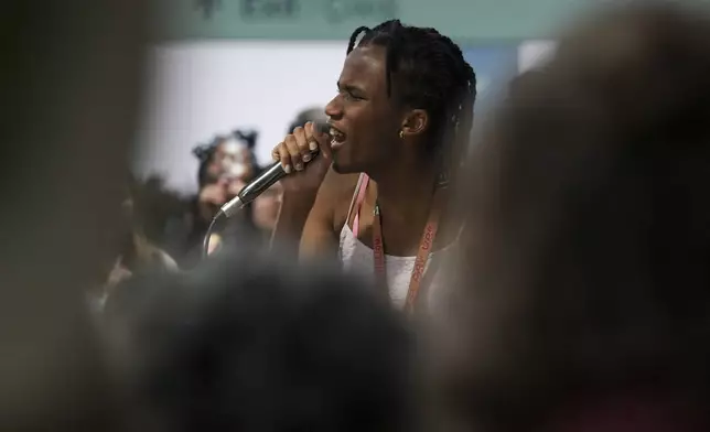 Activist Erica Njuguna speaks during a demonstration on climate finance at the COP29 U.N. Climate Summit, Wednesday, Nov. 20, 2024, in Baku, Azerbaijan. (AP Photo/Peter Dejong)