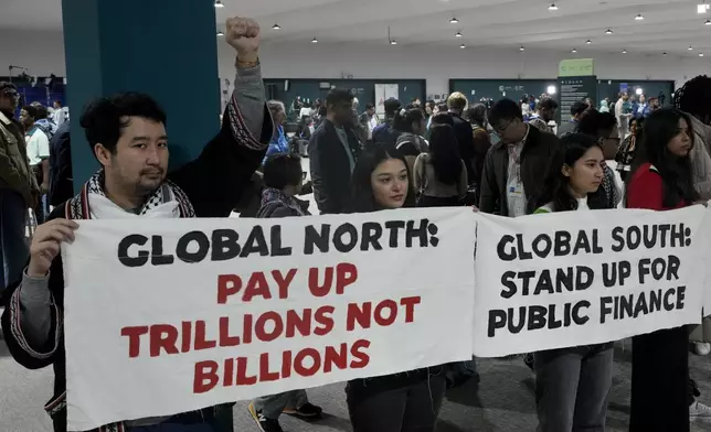 Activists demonstrate for climate finance at the COP29 U.N. Climate Summit, Wednesday, Nov. 20, 2024, in Baku, Azerbaijan. (AP Photo/Rafiq Maqbool)