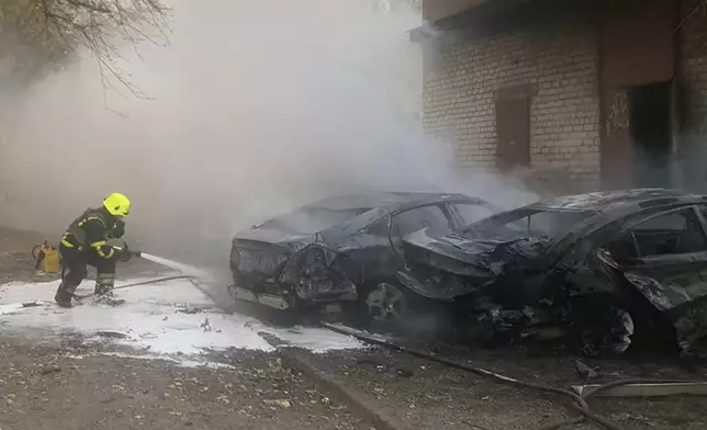 In this photo provided by the Ukrainian Emergency Service, emergency services personnel work to extinguish a fire following a Russian rocket attack in Poltava region, Ukraine, Sunday, Nov. 17, 2024. (Ukrainian Emergency Service via AP)